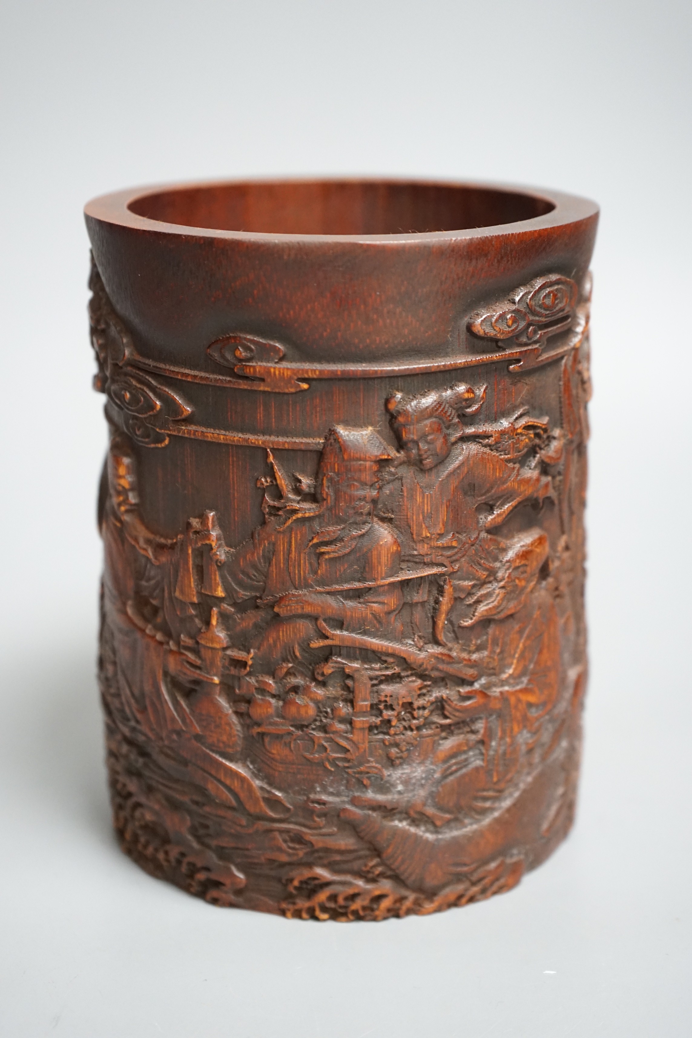 A Chinese 'immortals' carved bamboo brush pot, 16cm